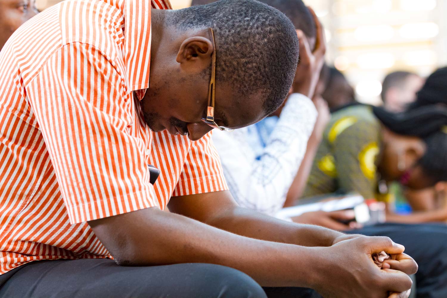 people bowing in prayer during church service